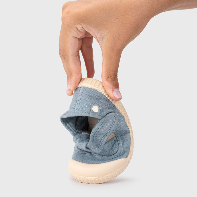 Open canvas shoes barefoot concept, Ocean