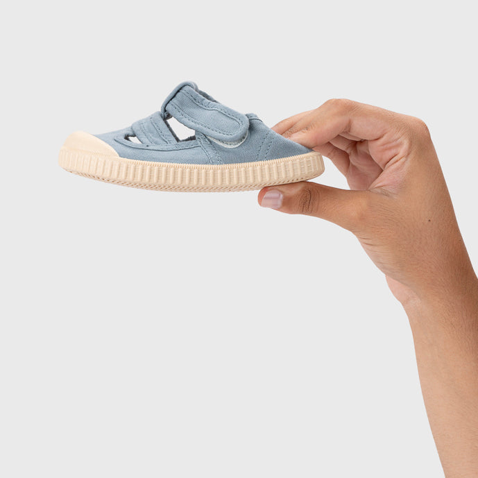 Open canvas shoes barefoot concept, Ocean